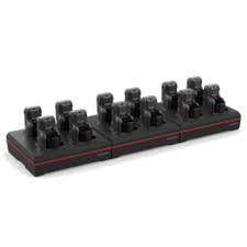 12 bay 8675i device charger with power supply (50143701-001). Charges complete 8675i unit with battery installed. Region-specific cord must be ordered separately. USB cable can be connected for communication with device when docked. (Honeywell MB12-SCN10)